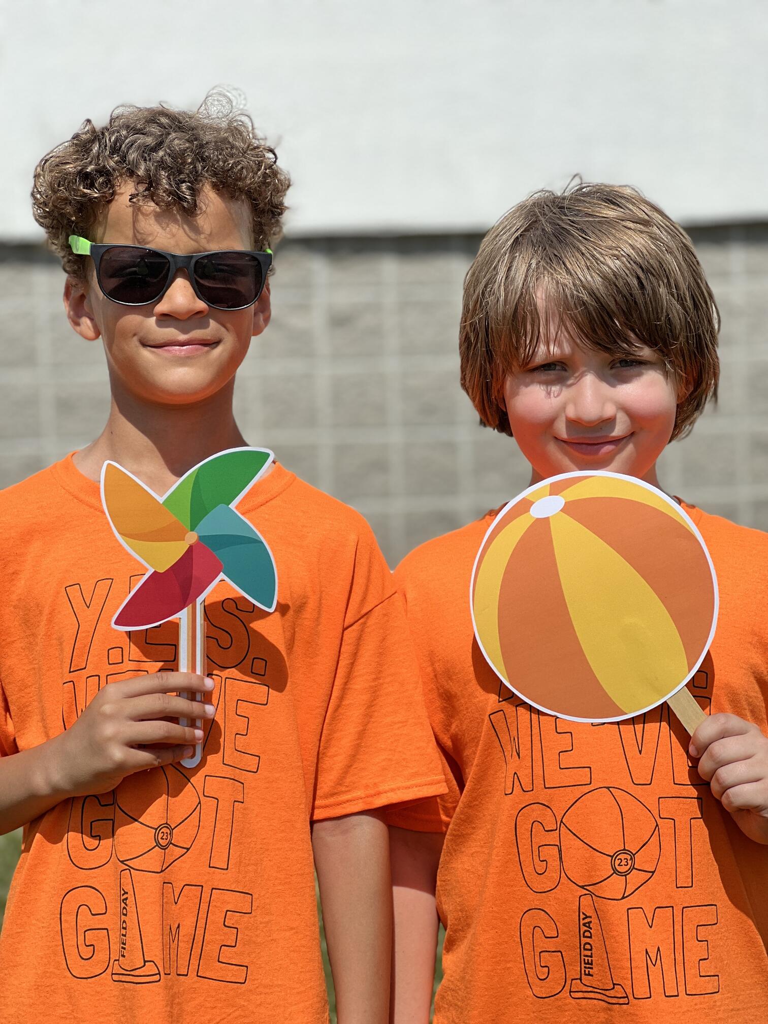 students at fun run holding game objects