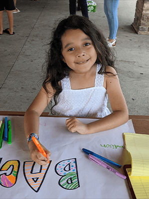 girl smiling while drawing