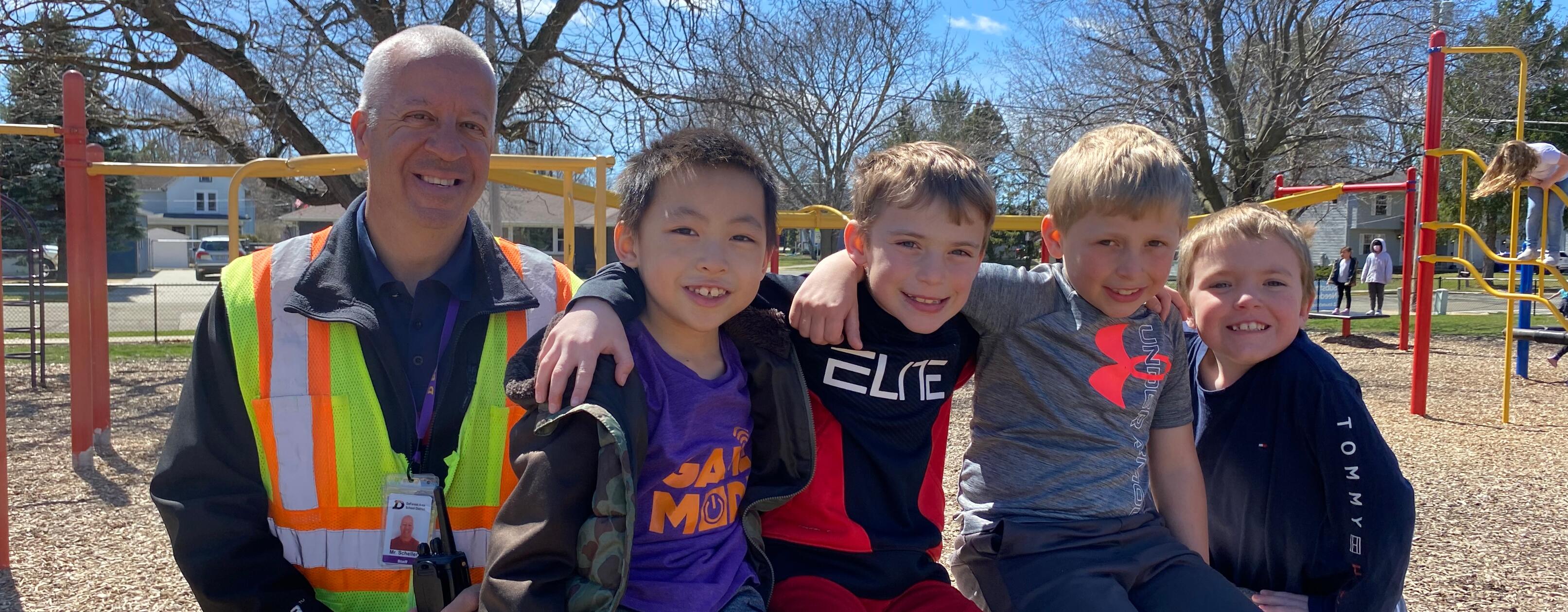 students and staff member outside at recess